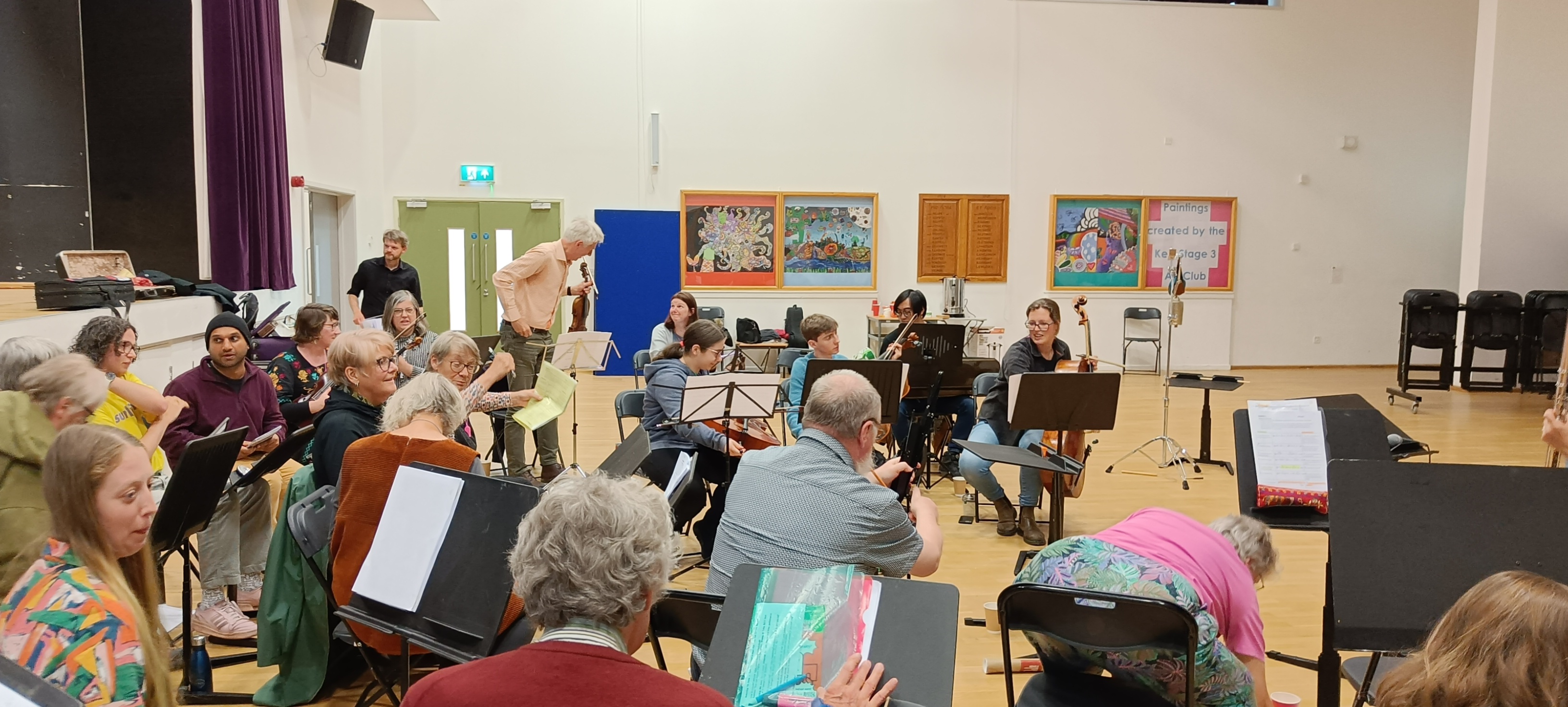 Second rehearsal in progress, musicians seated with music stands